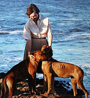 dogs and lady at water